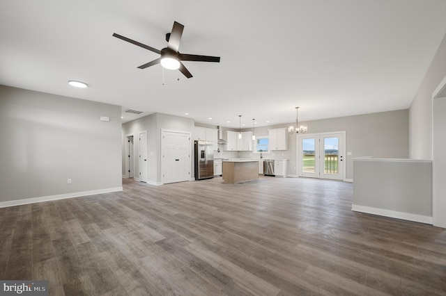 309 Gun Club Rd, Stephenson, VA 22656 - unfurnished living room with ceiling fan with notable chandelier, wood finished floors, baseboards, and visible vents