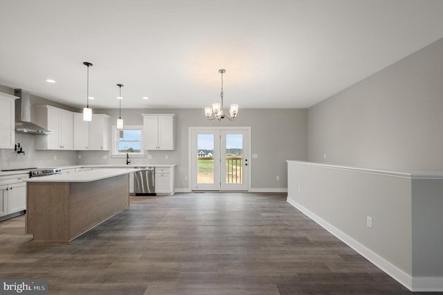 309 Gun Club Rd, Stephenson, VA 22656 - kitchen with an inviting chandelier, wall chimney range hood, dark wood-style floors, a center island, and stainless steel dishwasher
