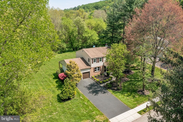 birds eye view of property with a forest view