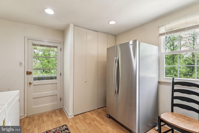kitchen with freestanding refrigerator, a healthy amount of sunlight, light wood-style flooring, and recessed lighting