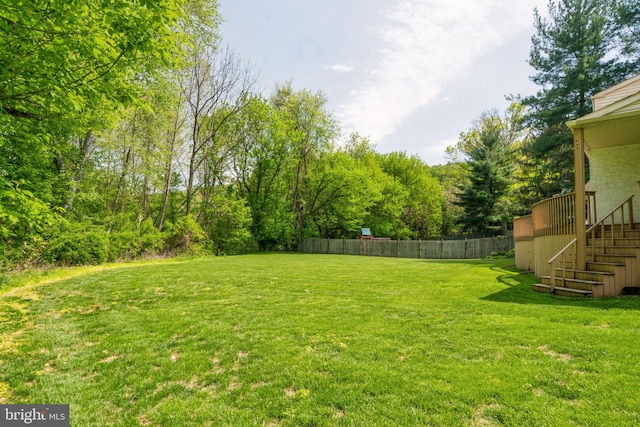 view of yard with stairway and fence