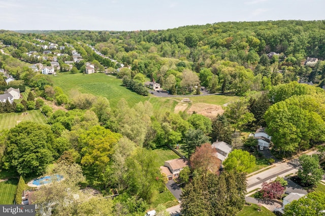 drone / aerial view featuring a wooded view