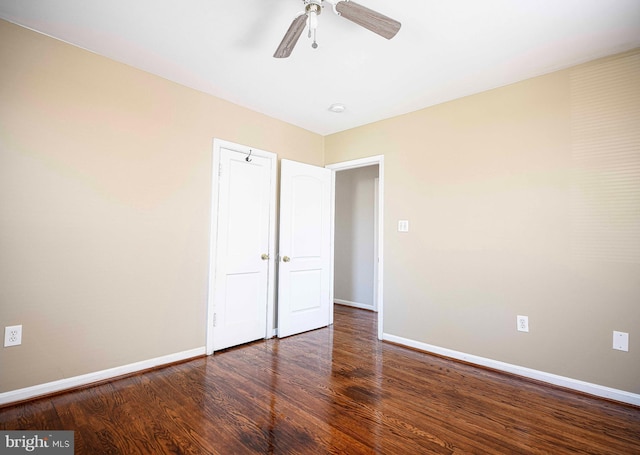 interior space with baseboards, a ceiling fan, and wood finished floors