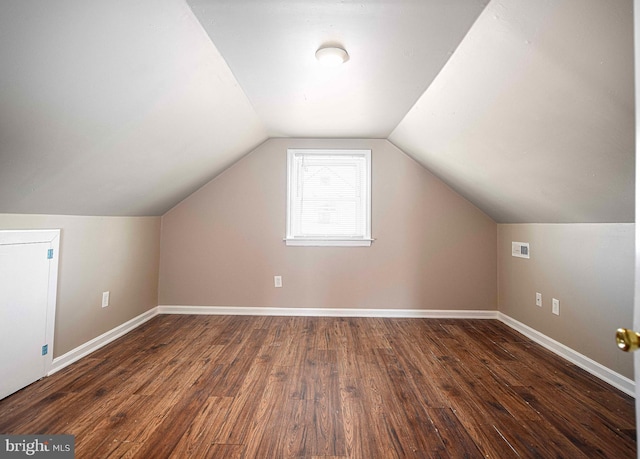 bonus room with wood finished floors, visible vents, baseboards, and lofted ceiling