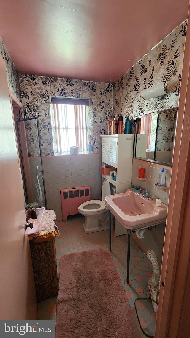 4951 Monument Rd, Philadelphia, PA 19131 - half bathroom with toilet, radiator heating unit, wallpapered walls, and tile walls