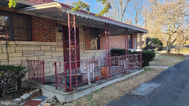 4951 Monument Rd, Philadelphia, PA 19131 - view of property exterior featuring brick siding and covered porch