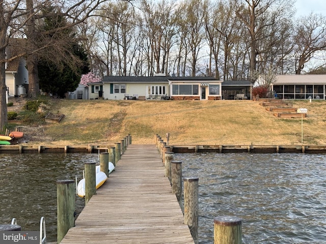 dock area featuring a water view and a yard