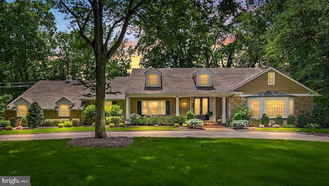21 Robin Rd, Moorestown, NJ 08057 - cape cod-style house with stone siding, a front lawn, and curved driveway