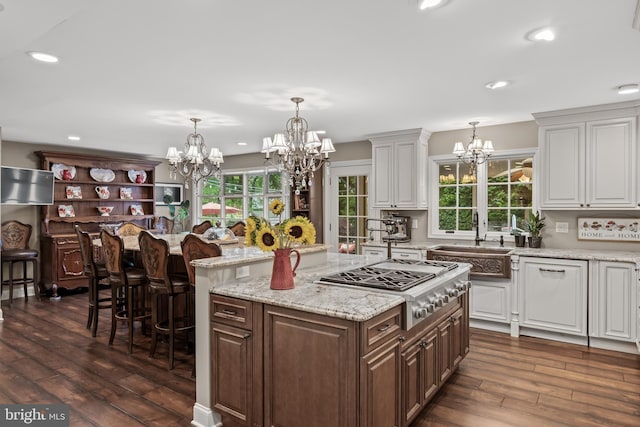 21 Robin Rd, Moorestown, NJ 08057 - kitchen with a chandelier, stainless steel gas stovetop, dark wood-style floors, a center island, and a sink