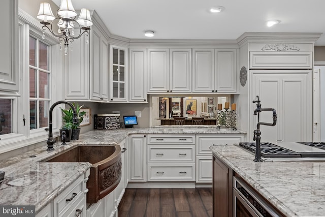 21 Robin Rd, Moorestown, NJ 08057 - kitchen featuring a sink, a chandelier, white cabinetry, and glass insert cabinets