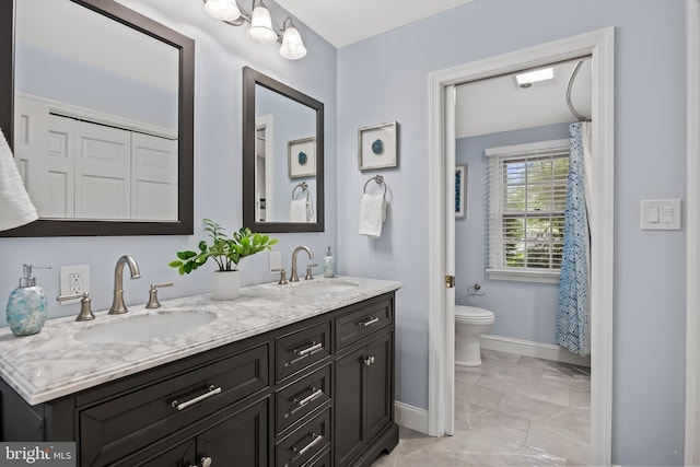 21 Robin Rd, Moorestown, NJ 08057 - bathroom featuring baseboards, double vanity, toilet, and marble look tiles