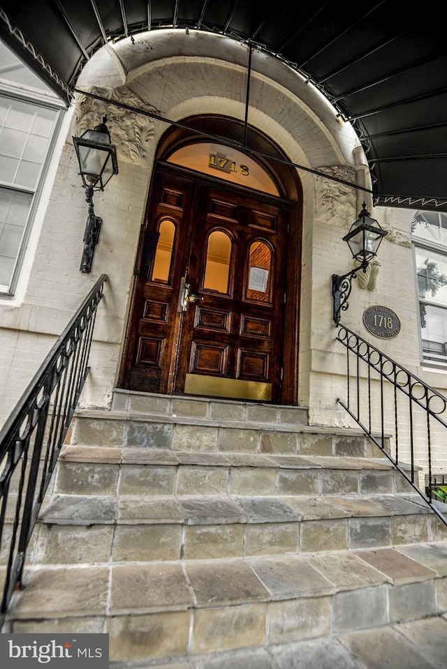 entrance to property featuring brick siding