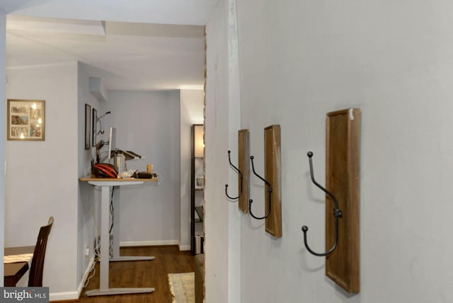 hallway with baseboards and wood finished floors