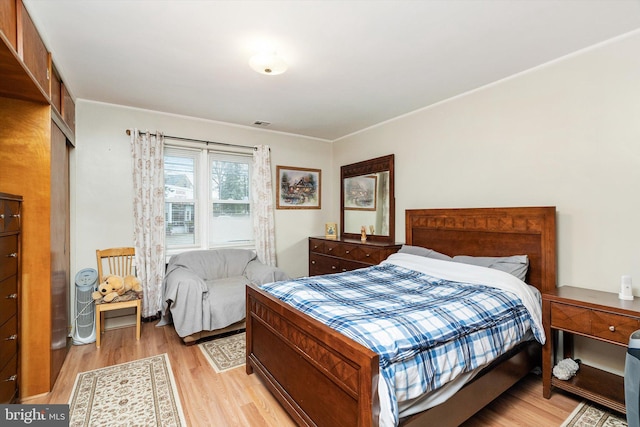 bedroom featuring light wood-type flooring and visible vents