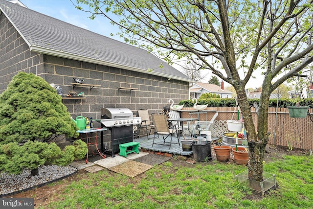 view of yard featuring a wooden deck and fence