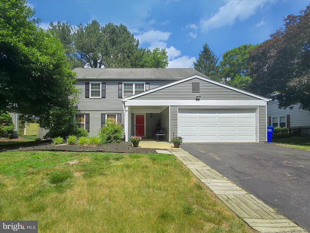 3115 New Coach Ln, Bowie, MD 20716 - view of front of home featuring a garage, aphalt driveway, and a front yard