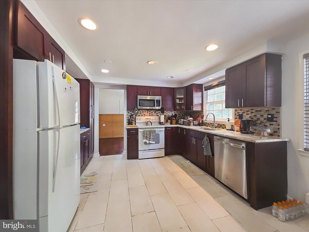3115 New Coach Ln, Bowie, MD 20716 - kitchen with recessed lighting, light countertops, backsplash, appliances with stainless steel finishes, and a sink