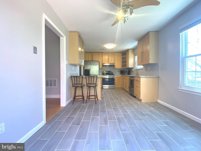 97 Kirkwood Dr, Newtown, PA 18940 - kitchen with tasteful backsplash, ceiling fan, appliances with stainless steel finishes, under cabinet range hood, and visible vents