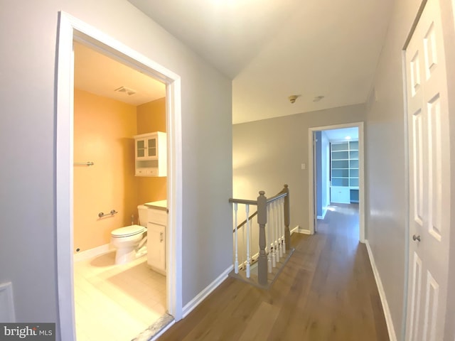 97 Kirkwood Dr, Newtown, PA 18940 - hallway featuring wood finished floors, baseboards, and an upstairs landing