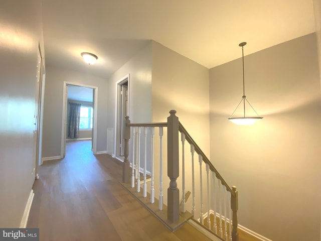 97 Kirkwood Dr, Newtown, PA 18940 - corridor featuring baseboards, wood finished floors, and an upstairs landing