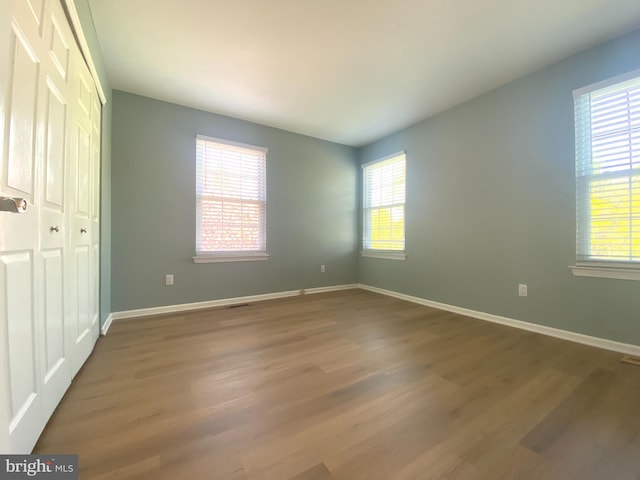 97 Kirkwood Dr, Newtown, PA 18940 - unfurnished bedroom featuring baseboards, wood finished floors, and a closet