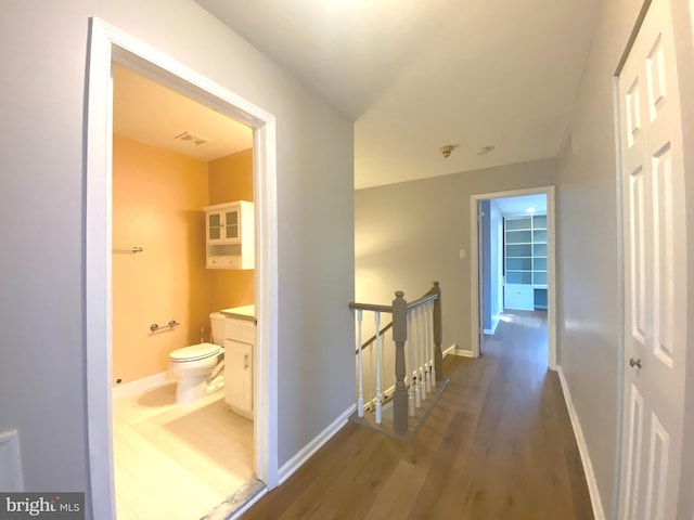 97 Kirkwood Dr, Newtown, PA 18940 - hallway featuring baseboards, wood finished floors, and an upstairs landing