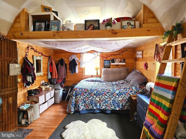 117 Roberts Rd, Great Cacapon, WV 25422 - bedroom with lofted ceiling, wood finished floors, and wooden walls