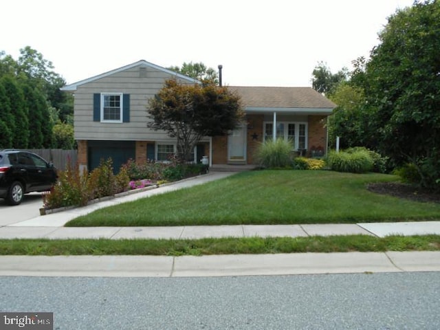 tri-level home featuring a front yard and an attached garage
