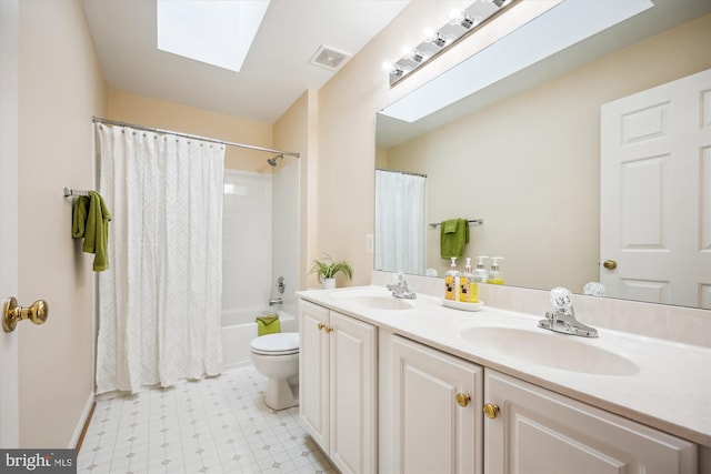 full bath with a skylight, toilet, a sink, and visible vents