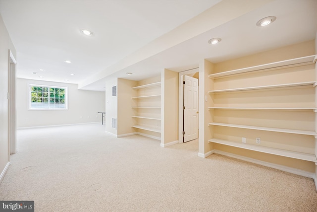 below grade area featuring recessed lighting, carpet flooring, baseboards, and visible vents