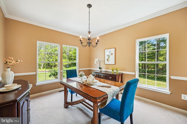 carpeted dining space with baseboards, a notable chandelier, and plenty of natural light