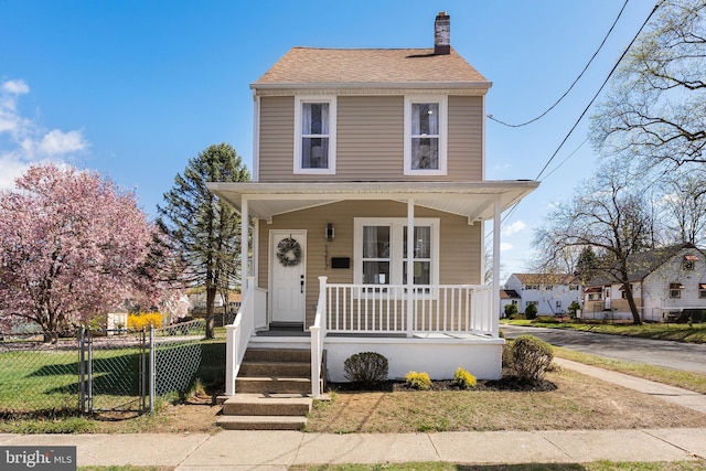 1217 Chestnut St, Burlington, NJ 08016 - traditional style home featuring a shingled roof, fence, covered porch, and a chimney