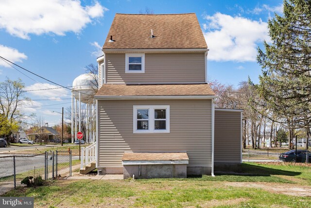 1217 Chestnut St, Burlington, NJ 08016 - exterior space featuring roof with shingles, fence, and a lawn