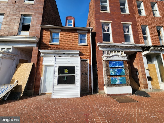 rear view of property with brick siding