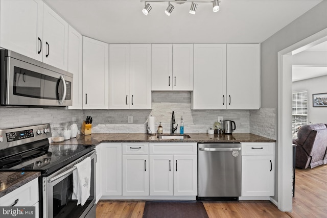 11200 Rienzi Pl Unit 201, Manassas, VA 20109 - kitchen featuring white cabinetry, dark stone countertops, stainless steel appliances, and a sink