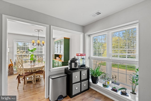 11200 Rienzi Pl Unit 201, Manassas, VA 20109 - doorway with a chandelier, light wood-style floors, and visible vents