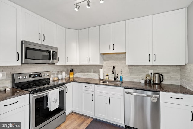 11200 Rienzi Pl Unit 201, Manassas, VA 20109 - kitchen featuring dark stone counters, white cabinets, stainless steel appliances, and a sink