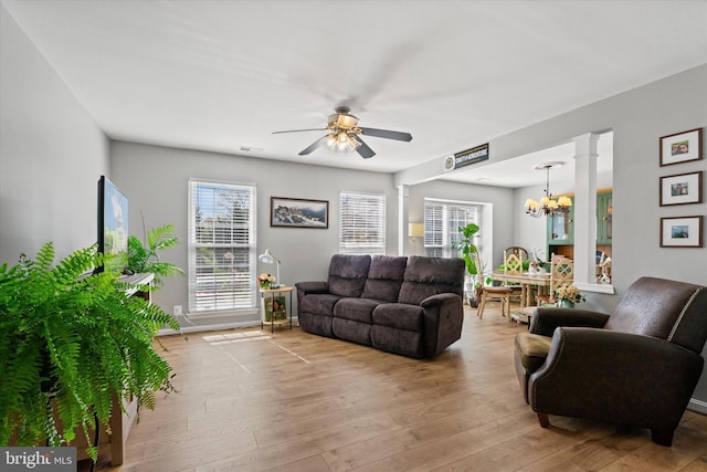 11200 Rienzi Pl Unit 201, Manassas, VA 20109 - living room with ornate columns, hardwood / wood-style flooring, and ceiling fan with notable chandelier