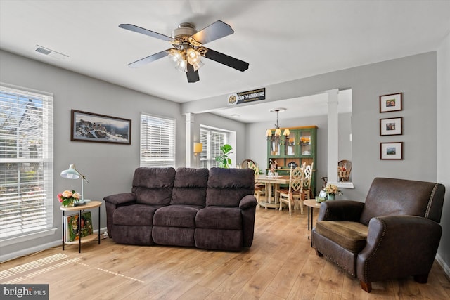 11200 Rienzi Pl Unit 201, Manassas, VA 20109 - living area with ceiling fan with notable chandelier, light wood-style flooring, visible vents, and ornate columns