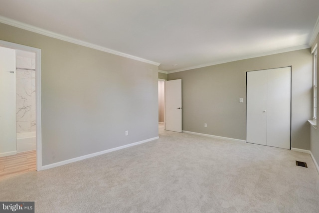 unfurnished bedroom featuring crown molding, baseboards, visible vents, and light carpet