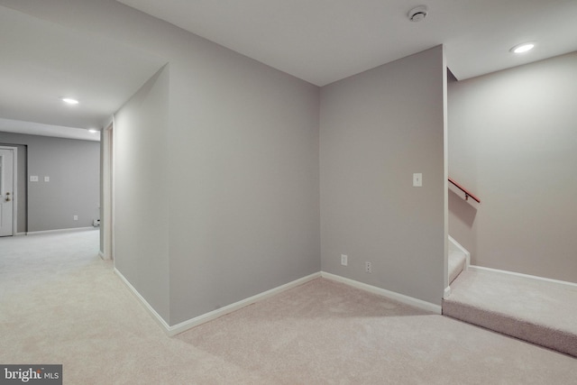 interior space featuring recessed lighting, baseboards, and light colored carpet