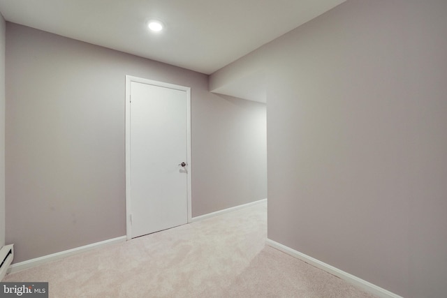 carpeted spare room featuring recessed lighting, baseboards, and baseboard heating