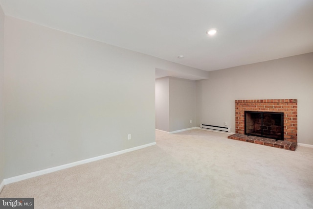 unfurnished living room with carpet flooring, baseboards, a baseboard heating unit, and a fireplace