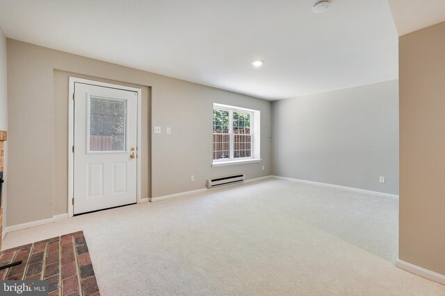 carpeted foyer with baseboards and a baseboard radiator