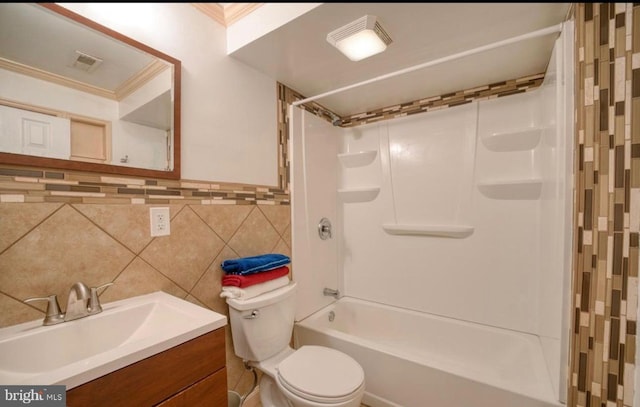 full bath featuring tile walls, toilet, crown molding, vanity, and bathing tub / shower combination