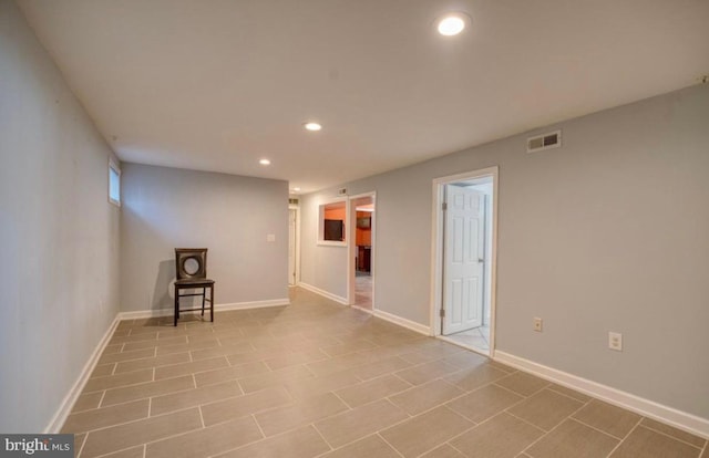 unfurnished room featuring baseboards, visible vents, and recessed lighting
