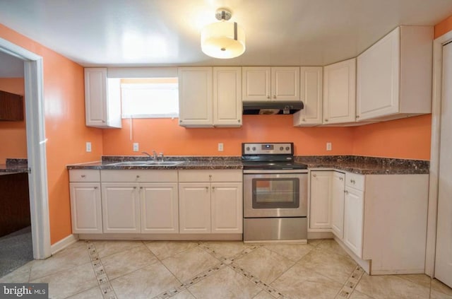 kitchen with electric range, white cabinets, under cabinet range hood, a sink, and dark countertops
