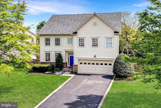 view of front facade with a garage, fence, aphalt driveway, a shingled roof, and a front yard