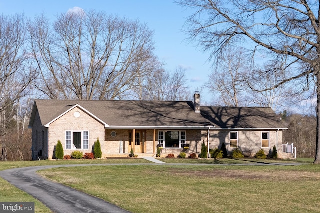 901 Riverside Ave, Grottoes, VA 24441 - ranch-style house with a front yard, brick siding, a chimney, and covered porch