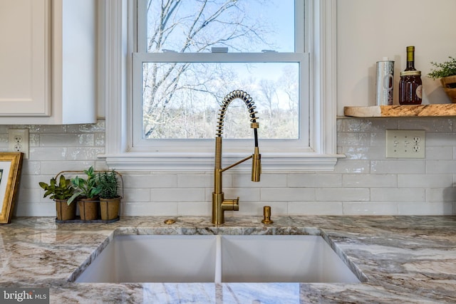 901 Riverside Ave, Grottoes, VA 24441 - interior details featuring light stone counters, decorative backsplash, a sink, and white cabinetry